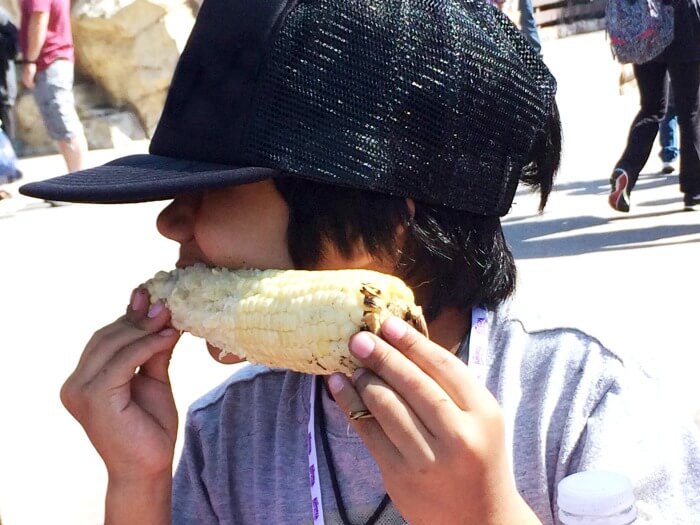 Logan Cordova eating corn at Knott's Berry Farm