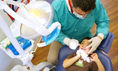 Colgate dentist checking child's teeth