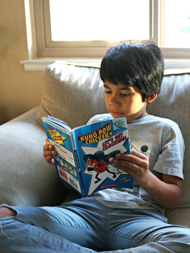 Boy reading Kung Pow Chicken