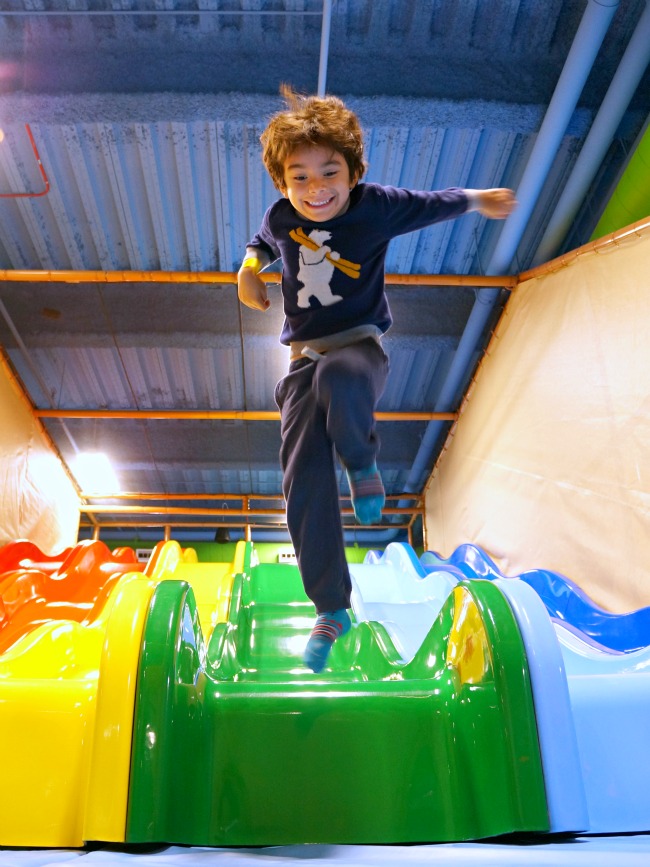 Boy jumping from colorful slides at Billy Beez in Anaheim // LivingMiVidaLoca.com