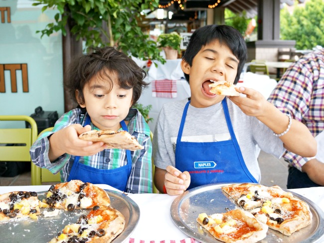 Latino kids eating pizza at Naples Ristorante // Pizza Party at Downtown Disney // LivingMiVidaLoca.com