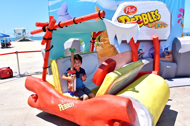 Latino kid taking a picture on Flintmobile