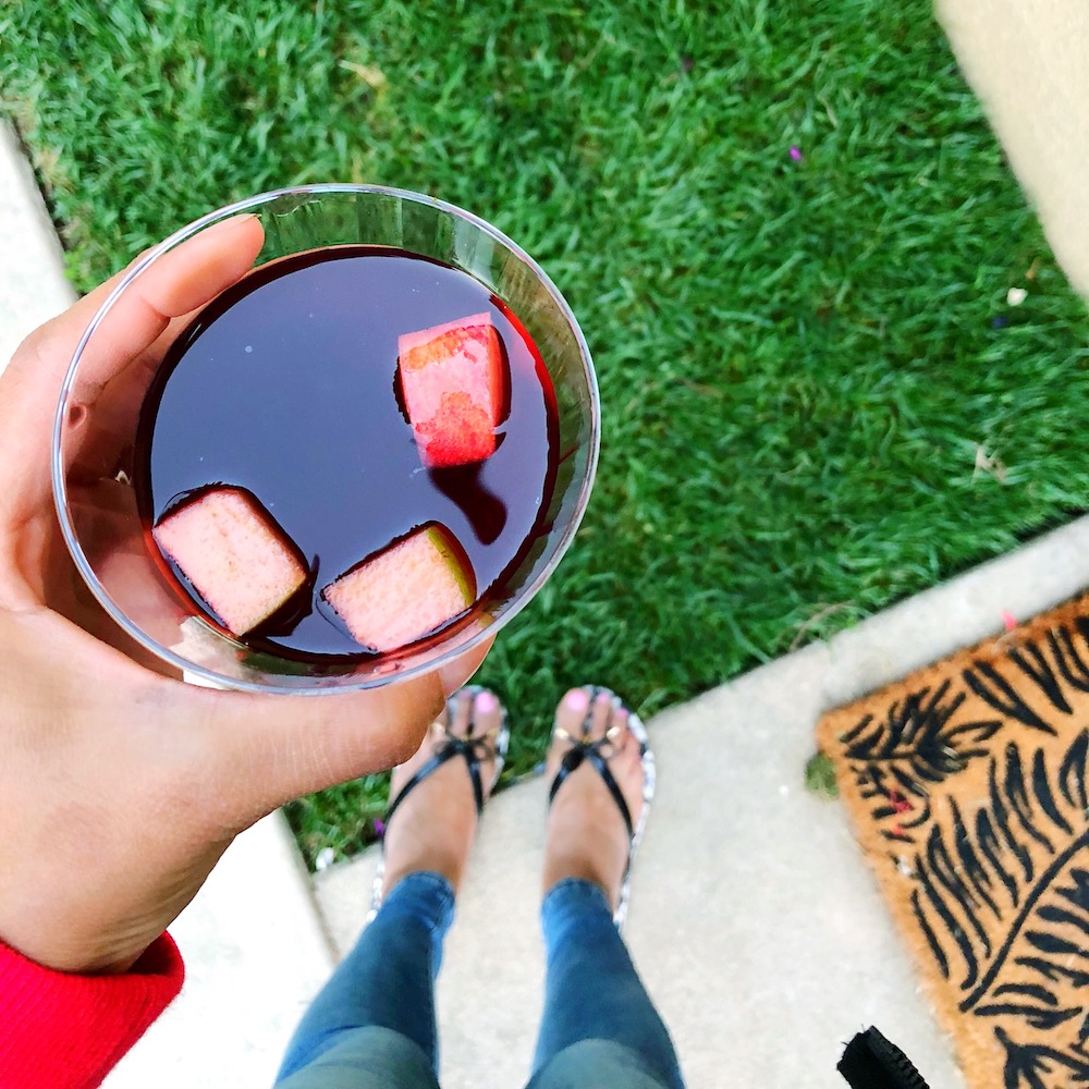 cup of boysenberry sangria outside on lawn