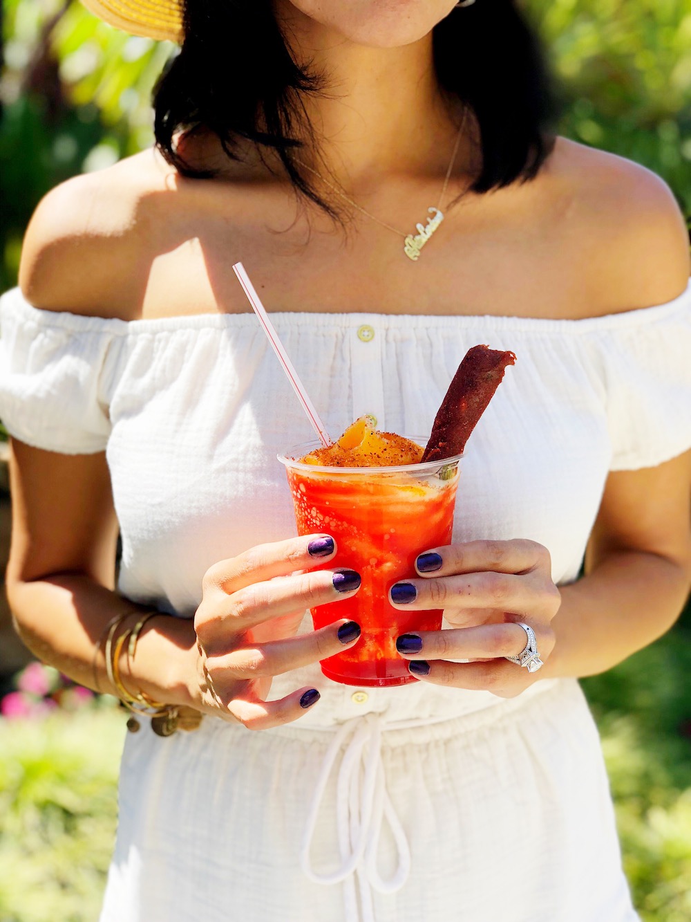 new mango chamoy icee with tajin topping with white dress in the background - livingmividaloca.com