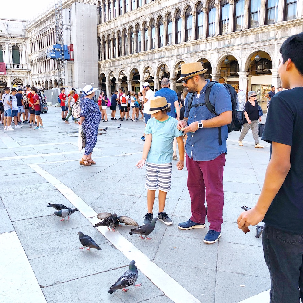 Feeding pigeons in Venice Italy