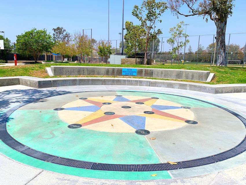 Heritage park has a small circular area with floor water spouts.