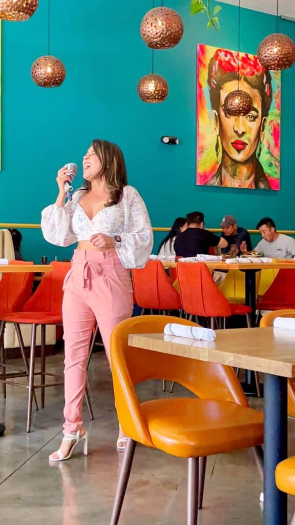 Jacqueline in pink pants singing at Corazon Modern Kitchen in Brea